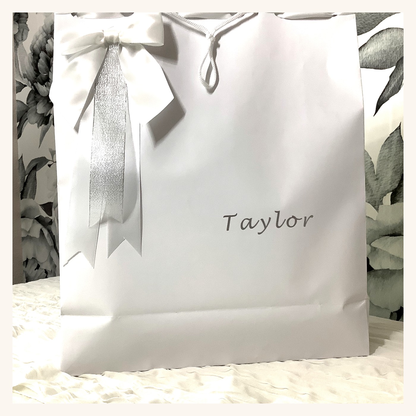 White P.S. I Do bridal gift bag personalized with the bride's name and finished with satin bows