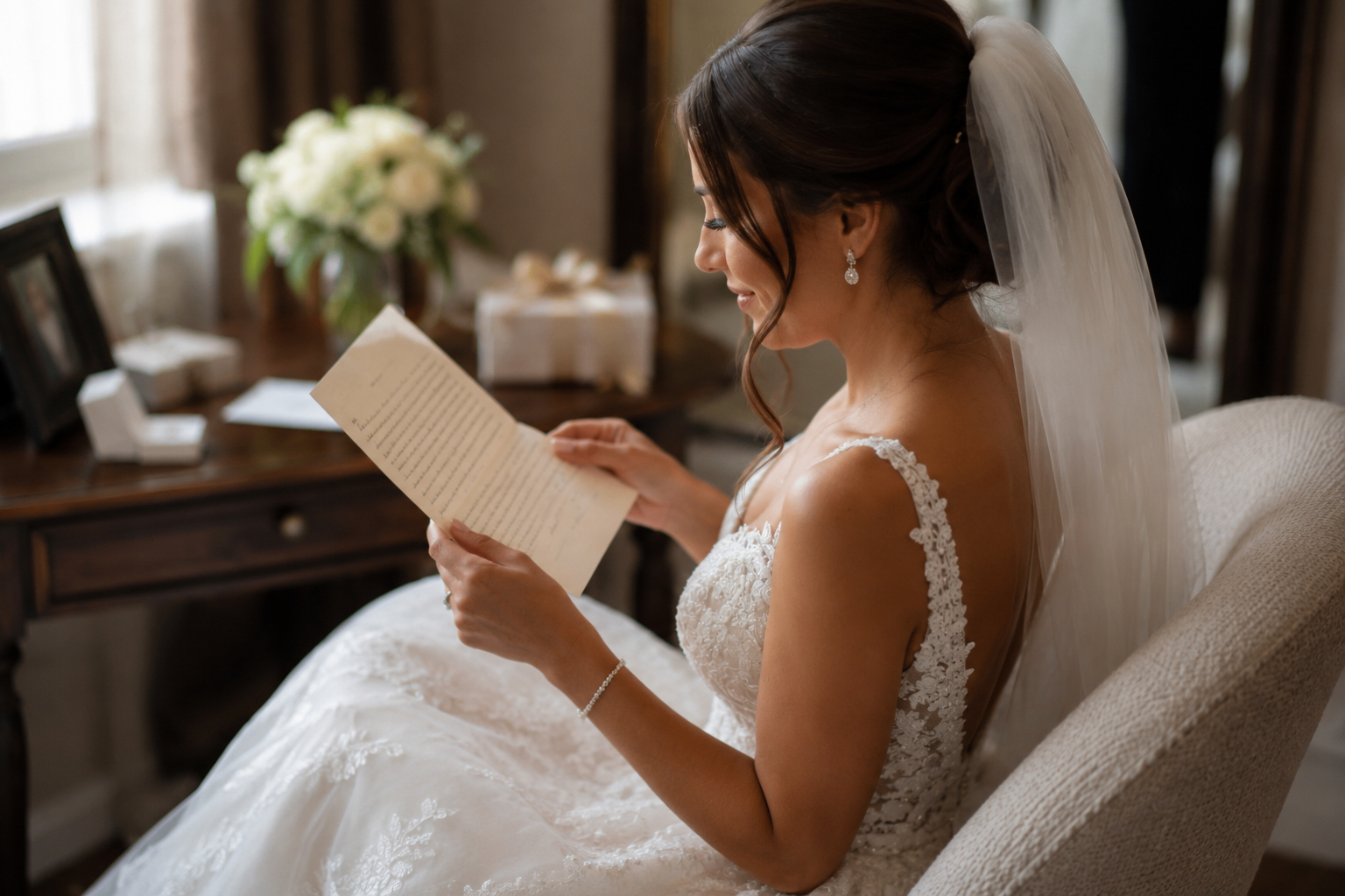 Bride in wedding dress reading a heartfelt love letter
