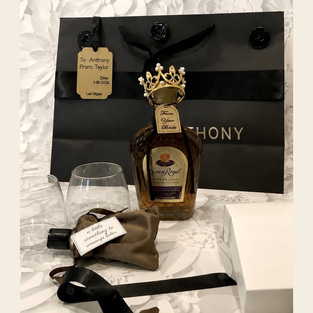 Crown Royal bottle with a gold crown and 'From Your Bride' tag beside elegant disposable rocks glasses