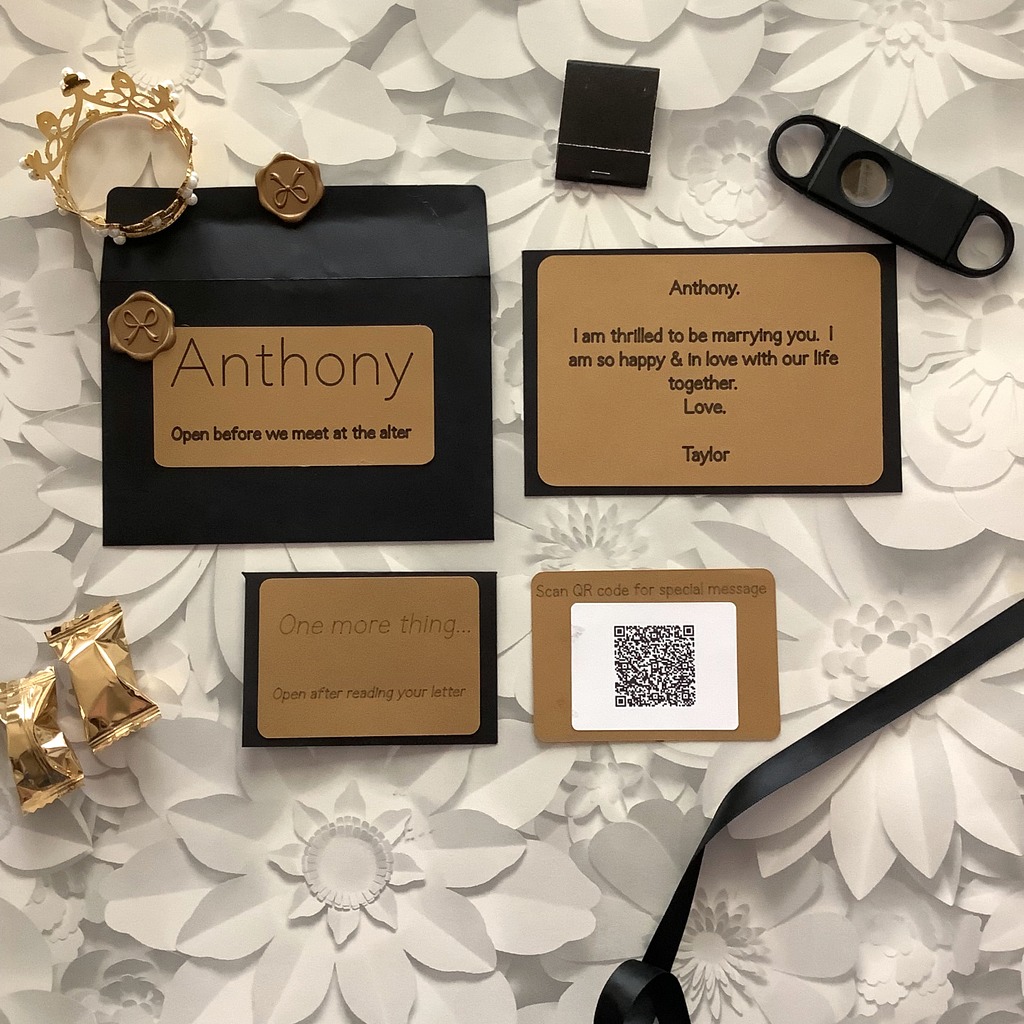Personalized gold keepsake card printed with the letter, tucked into a black envelope sealed with a gold wax bow